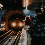 Commuters on a platform as a metro train approaches