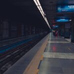 Passengers waiting on a dimly lit metro station platform