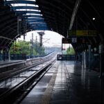 An empty metro station with wet tracks after rain