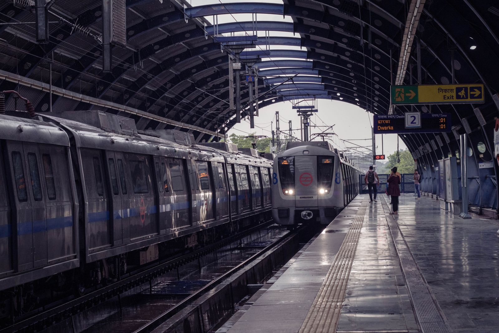 A metro train arriving at an elevated station platform